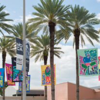 Flags with a message kick off another round of MOCA’s Art on the Plaza