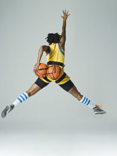 Holly Bass’ “NWBA (jordan)” 2012 freezes the artist in midair, her silhouette transformed through the incorporation of basketballs in a photograph. (