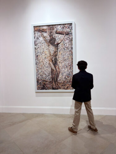 Belen Jesuit student views Brazilian artist Vik Muniz’s “The Crucifixion, after Thomas Eakins” (2011), collage, in “The Light of the World,” curated by Carol Damian and Adriana Herrera, on view through Wednesday, May 6. (Photo by Suzzane Sardina and Ignacio Font, courtesy of Saladrigas Gallery at Belen Jesuit Preparatory School)