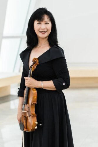 Concertmaster Mei Mei Luo steps into the solo spotlight on violin for Pablo Sarasate’s “Fantasy on Carmen” during the Miami City Ballet orchestra's upcoming performance, “Ballet Classics Under the Stars,” at the Sanctuary of the Arts.